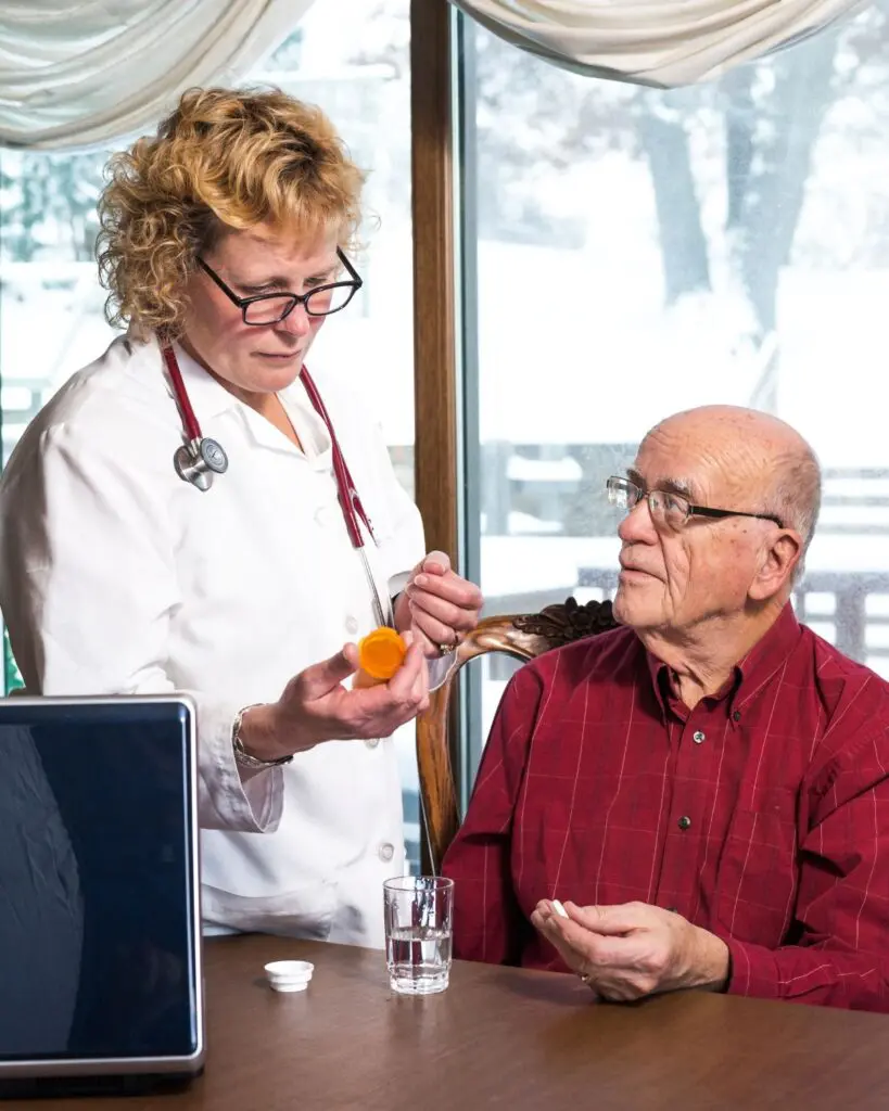 A Home Health Care professional dispensing medicine for a patient