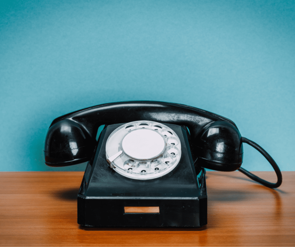 Old phone on wooden table