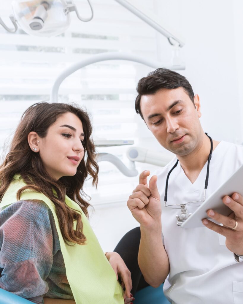 A dentist consulting his female patient