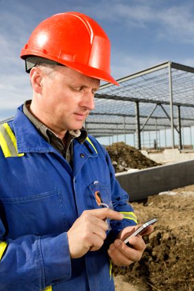 Construction worker answering text